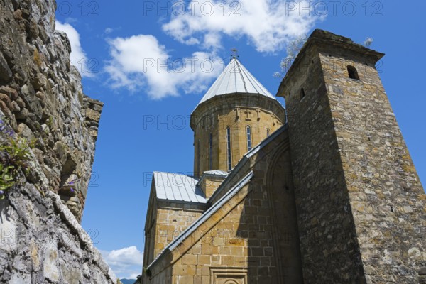 Medieval church building with a high tower and a blue sky in the background, Ananuri Castle, Zhinvali Reservoir, Jinvali or Shinvali, Mtskheta-Mtianeti Region, Georgian Military Highway, Georgia