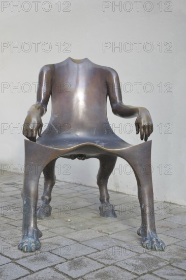 Sculpture The Bub by Lun Tuchnowski, modern art, bronze sculpture, empty chair as an animal figure without head, none, missing, headless, armrest, ungulate, paws, hybrids, curious, funny, marketplace, Nördlingen, Bavaria, Germany
