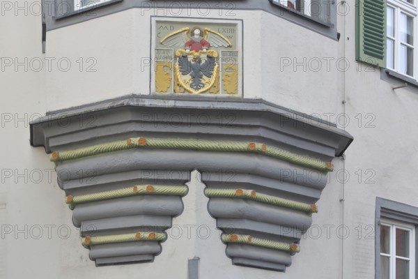 City coat of arms at the former Holy Spirit Hospital building built in 1564, house corner, inscription, year, eagle figure, heraldic animal, care center, Bürgerheim, Nördlingen, Bavaria, Germany