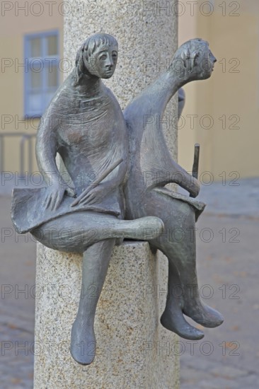 Sculpture Reading people artist unknown, two seated figures reading and writing in a book, book reader, modern art, bronze sculpture, Karl-Schlierf-Platz, Nördlingen, Bavaria, Germany