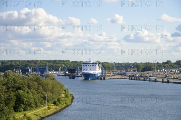Scandinavienkai Tavemünde with large Finnlines ferry in port, surrounded by water and fluffy clouds, Travemünde, Lübeck, Schleswig-Holstein, Germany