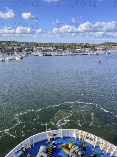 View from a ship's hull across the water towards the harbor entrance, Travemünde, Lübeck, Schleswig-Holstein, Germany