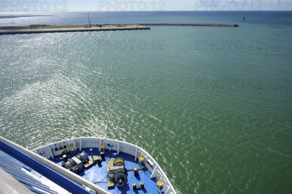 Front view of a TT-Line ferry leaving the port exit under a blue sky with a clear horizon, Trelleborg, Skåne län, Sweden
