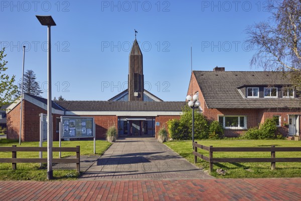 St. Ulrich Catholic Church, church tower, brick building material, entrance, showcase, lantern, wooden fence, front garden, lawn, duplex, blue sky, cloudless, bathing alley, Sankt Peter-Ording, Nordfriesland district, Schleswig-Holstein, Germany