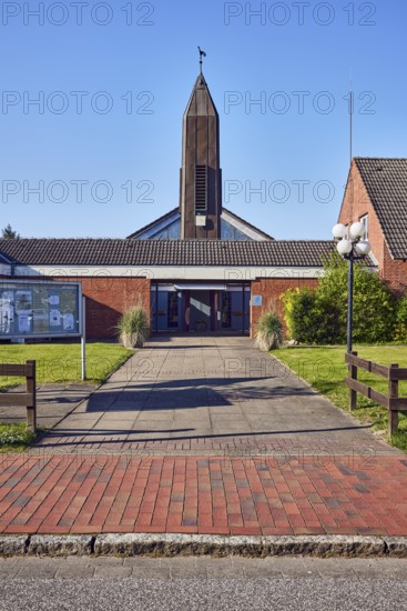 St. Ulrich Catholic Church, church tower, brick building material, entrance, display case, lantern, wooden fence, front garden, lawn, blue sky, cloudless, bathing alley, Sankt Peter-Ording, district of North Frisia, Schleswig-Holstein, Germany