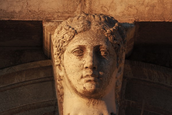 Head of a woman on the colonnade of the Biblioteca Nazionale Marciana (National St Mark's Library) in the Piazzetta, Venice, Veneto, Italy
