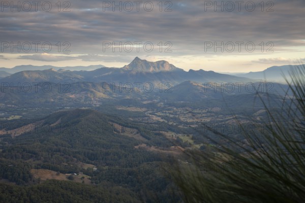 Sunset with an open view across the valley toward Mount Warning (Wollumbin), captured from the summit of Mount Cougal, highlighting natural depth and wide landscape perspective, Queensland and New South Wales, Australia
