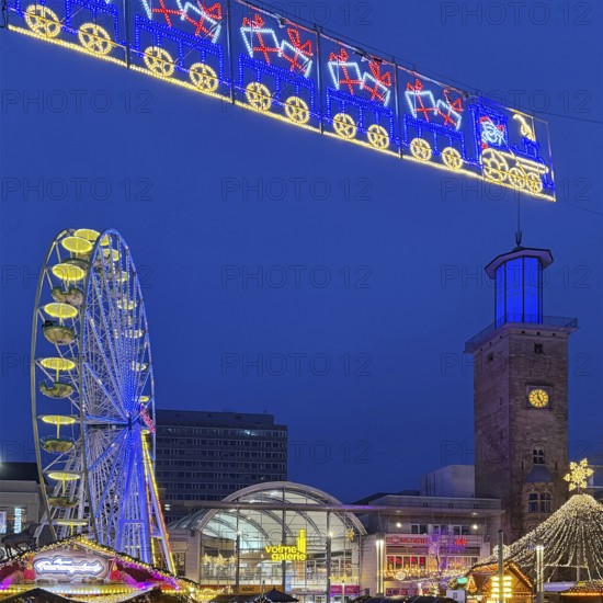 The Ferris wheel at the Christmas market at the Volme Gallery and the Town Hall Tower in the evening, Hagen, Ruhr area, North Rhine-Westphalia, Germany