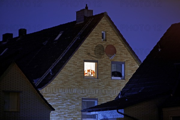 Illuminated window of a residential building in a settlement at night, Witten, Ruhr region, North Rhine-Westphalia, Germany
