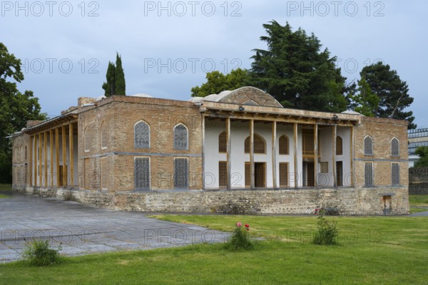 Old building with impressive brick walls and elegant columned entrance in garden surroundings, Batoni Castle, Batonis Ziche fortress, Telavi, Kakheti region, Georgia