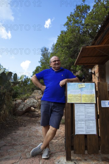 Corsican man, 67 years old, checks the entrance to the Genoese Tower of Porto, Ota, west coast of Corsica, Corse-du-Sud, Corsica, France