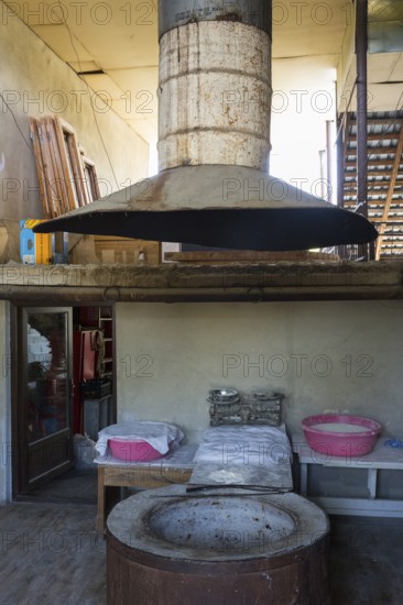 Large traditional oven with extractor hood in a rustic industrial setting, bakery, Badiauri, Kakheti region, Georgia