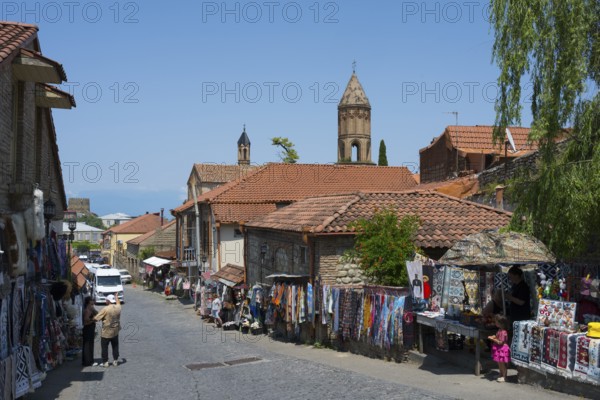 A lively market street in a village with people buying souvenirs at colorful stalls, Old Town, Sighnaghi, Signagi, Kakheti Province, Greater Caucasus, Georgia, Western Asia