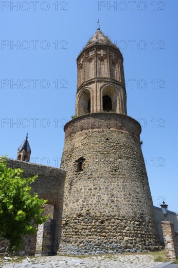 Close-up of a medieval tower under bright blue sky in an old town, St. George Church, St. George, old town, Sighnaghi, Signagi, Kakheti province, Greater Caucasus, Georgia, Western Asia
