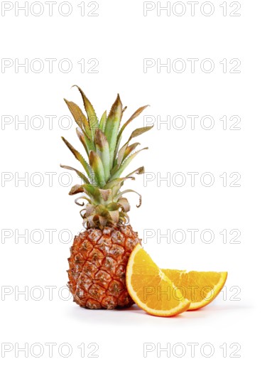 Fresh pineapple and orange slices arranged on a white background, vertical, no people