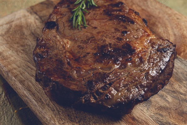 Grilled steak, beef steak, rib eye steak, on a chopping board, top view, no people