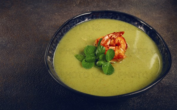 Pea cream soup, with shrimp, green soup, homemade, top view, no people