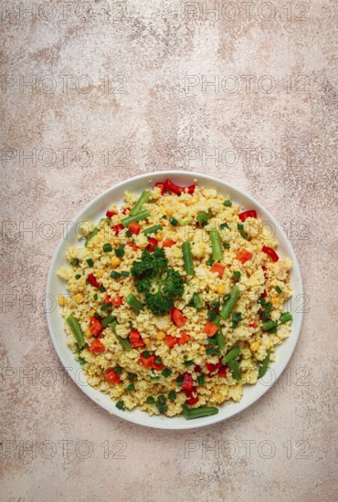 Couscous with vegetables, paprika, carrots, string beans, corn, homemade, top view, no people