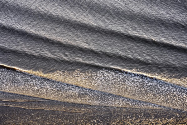 Small waves run on the beach