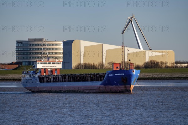Danish cargo ship Ernst Hagedorn, anchored in the mouth of the Weser, in the background the Fraunhofer Institute for Wind Energy Systems IWES, left, Bremerhaven, Germany