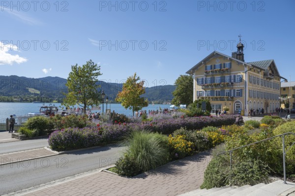 Historic town hall, tourists on the promenade on the banks of Tegernsee, flower beds in the foreground, town of Tegernsee, Upper Bavaria, Bavaria, Germany
