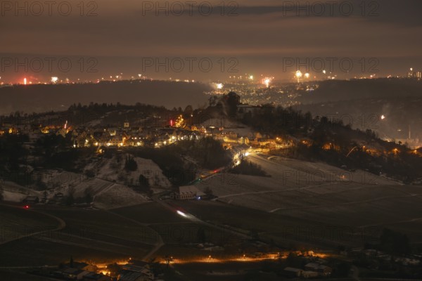 New Year's Eve view from Kapellberg near Fellbach towards Rotenberg. View of the grave chapel in Württemberg as fireworks rockets and firecrackers illuminate the night sky over Stuttgart on New Year's Eve from 2025 on 2026 at the turn of the year