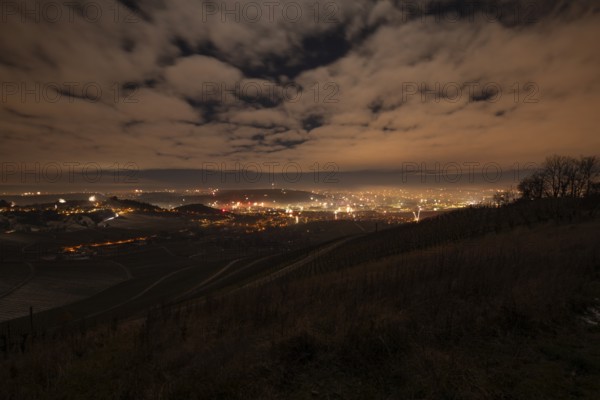 New Year's Eve view from Kapellberg near Fellbach towards Rotenberg Neckar Valley and Stuttgart. View of the grave chapel in Württemberg as fireworks rockets and firecrackers illuminate the night sky over Stuttgart on New Year's Eve from 2025 on 2026 at the turn of the year