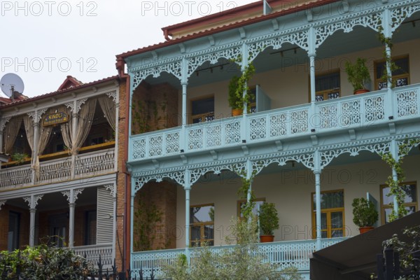 Traditional Caucasian architecture with decorated balconies and wooden railings decorated with plants, Tbilisi, Tbilisi, Georgia