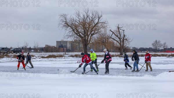 Detroit, Michigan USA - 1 January 2026 - As temperatures dropped and snow fell in the Great Lakes region, people shoveled ice off Lake Okonoka in Belle Isle State Park to play ice hockey on New Year's Day