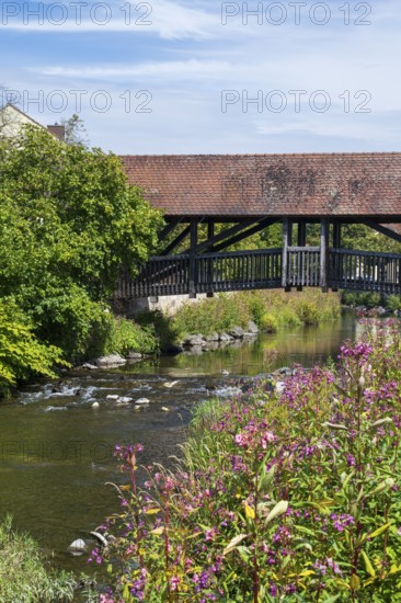 Covered footbridge over the Kronach river, hospital bridge, Blooming flowers on the shore, Kronach, Upper Franconia, Franconia, Bavaria, Germany