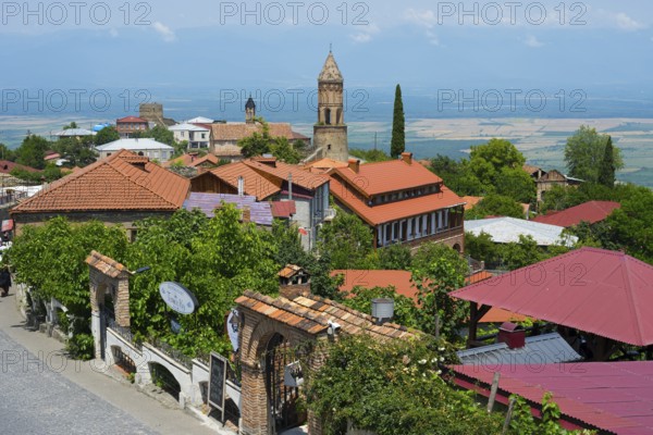 City view with church tower and red roofs under blue sky, Church of St. George, Sighnaghi, Signagi, Kakheti Province, Greater Caucasus, Georgia, Western Asia