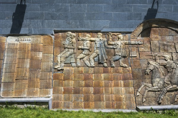 Stone relief with figures and memorial plaque in a historical illustration, commemoration of World War II, Sighnaghi, Signagi, Kakheti province, Greater Caucasus, Georgia, Near East Asia