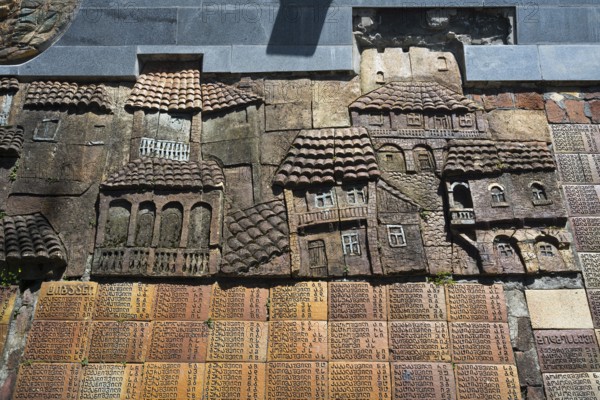 Stone relief with architectural details of traditional houses on a wall, commemoration of World War II, Sighnaghi, Signagi, Kakheti province, Greater Caucasus, Georgia, Western Asia