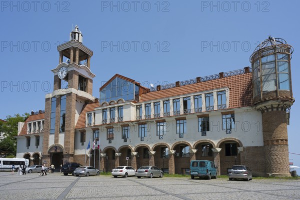 Historic building with clock tower and vehicles in the foreground under clear sky, City Hall, Sighnaghi, Signagi, Kakheti Province, Greater Caucasus, Georgia, Western Asia