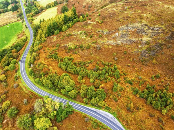 Autumn colours of Farms over River Wye and Road A470 from a drone, Llanidloes, Powys, Montgomeryshire, Wales, UK