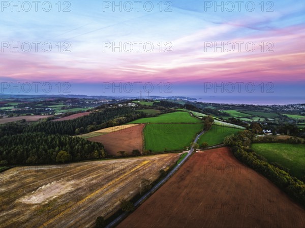 Sunset of Devon Farms and Fields over Berry Pomeroy from a drone, Totnes, England, United Kingdom