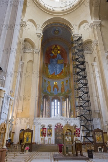 The interior of a church with tall columns, frescoes and an impressive altar, Sameba Cathedral, Trinity Cathedral, Tbilisi, Georgia