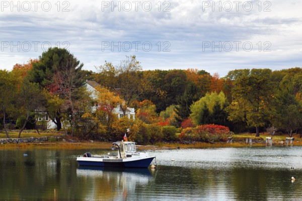 Scenic river landscape, lobster boat, riverbank fishing boat, autumn leaves, Indian summer, Kennebunk River, Maine, New England, USA