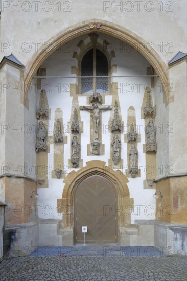 Church portal with crucifix and figures, monastery church decorations built in the 15th century, Benedictine monastery, church door, Blaubeuren, Swabian Jura, Baden-Württemberg, Germany