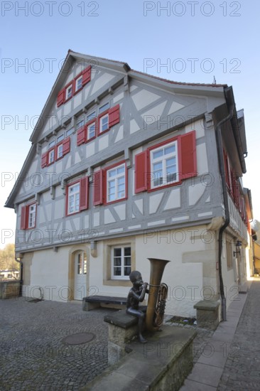 Sculpture boy with tuba by Guido Messer 1991, music school, half-timbered house, making music, tuba, tuba, brass instrument, jack, Waldenbuch, Baden-Württemberg, Germany