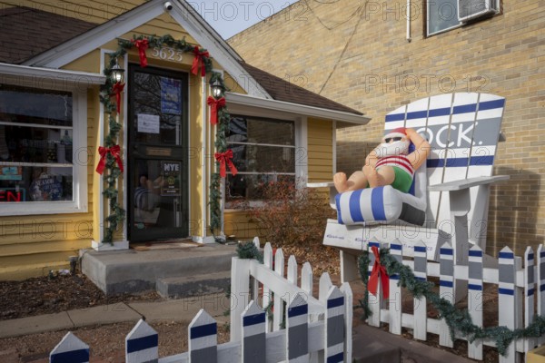 Arvada, Colorado - A blow-up Santa lounges in a beach chair outside a store in Olde Town Arvada as the temperature reached 70F on Christmas Eve