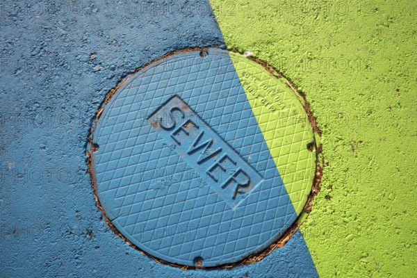 Arvada, Colorado - A brightlyl-colored manhole cover which leads to the city's sewer