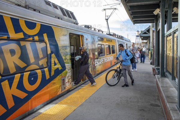 Arvada, Colorado - Passengers board Denver's light rail train system at the Olde Town Arvada station