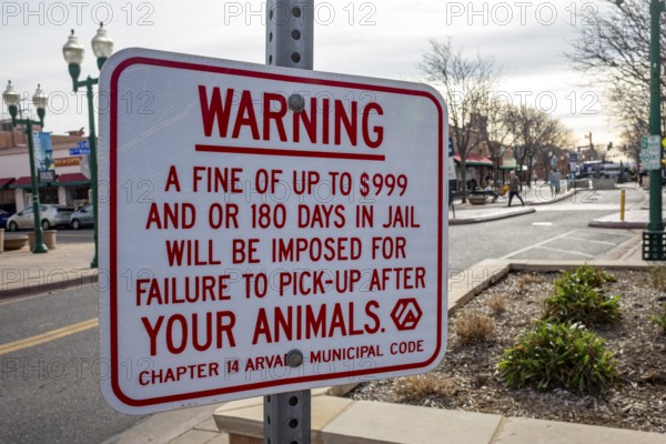 Arvada, Colorado - A sign in Olde Town Arvada lists the consequences for failing to pick up your animal's droppings