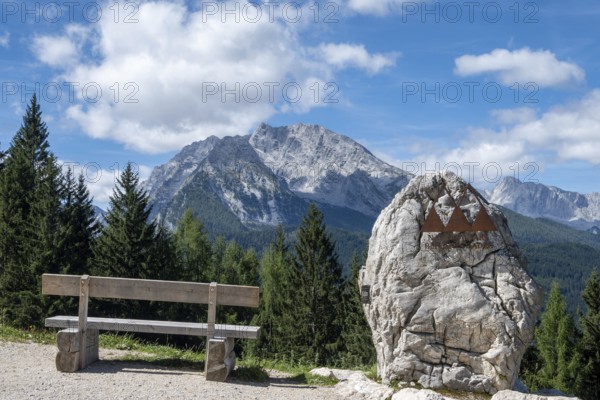 Bench and symbol of the Berchtesgaden National Park on its border, with the Watzmann in the background, Bavaria, Germany