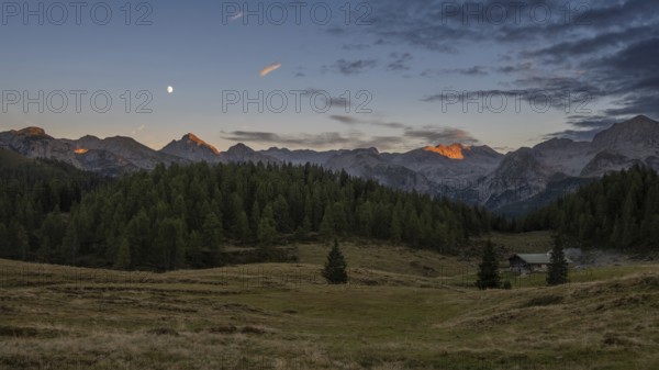 View over the Gotzenalm alpine pasture to the Teufelshörner, Hochkönig and Steinernes Meer mountains at sunset, Berchtesgaden National Park, Bavaria, Germany