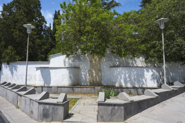 Small park with memorial and trees, surrounded by a white wall, modern lanterns illuminate the scene, memorial to the dead of the German colonists and their descendants, Bolnissi, Katharinenfeld, founded by Caucasian German settlers, Lower Kartli region, Kwemo Kartli, Georgia