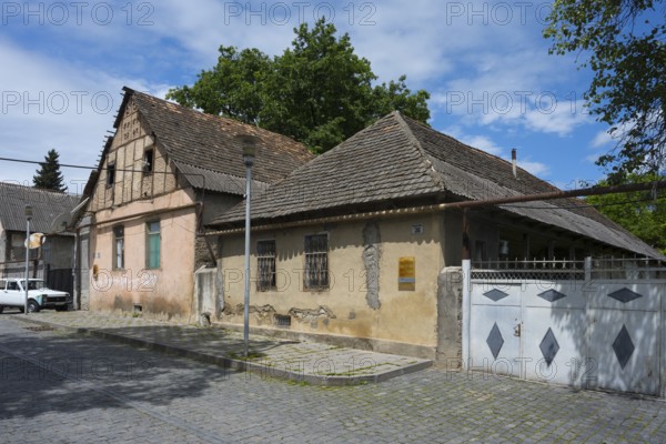 Two old houses with tiled roofs and weathered facades on a cobblestone street, traditional German residential building, Nikolaistraße 36, Bolnissi, Katharinenfeld, founded by Caucasian German settlers, Lower Kartli region, Kwemo Kartli, Georgia