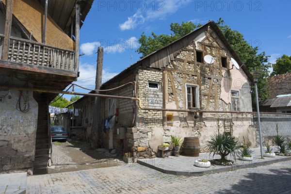 Traditional half-timbered stone house with a veranda in a quiet village street, traditional German residential building, Nikolaistraße 42, Bolnissi, Katharinenfeld, founded by Caucasian German settlers, Lower Kartli region, Kwemo Kartli, Georgia