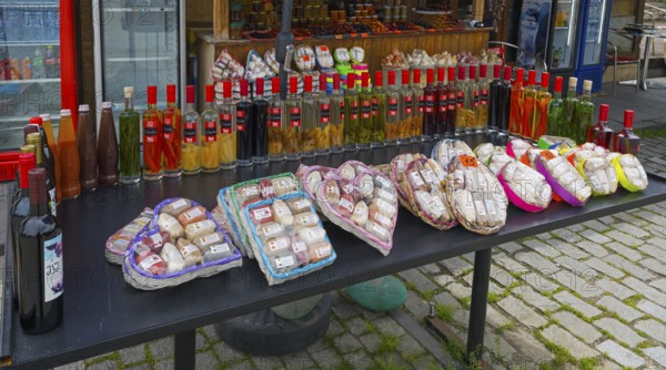 Diverse selection of spices and bottles at a traditional market stand, chacha with colorful fruits, vegetables or spices, pomace brandy, grape distillate, spices in front, Mtskheta, Mtskheta, Mtskheta, Mtskheta region, Georgia